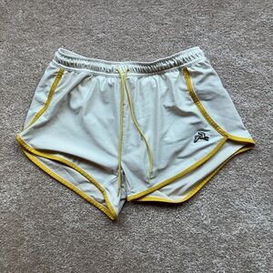 Tracksmith white van cortlandt shorts with yellow trim